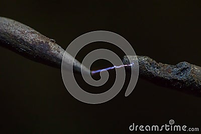 Electric cable close-up with glowing electricity lightning. Macro shot Stock Photo