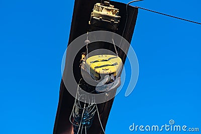 Electric cable hoist with black hook in yellow casing. Stock Photo