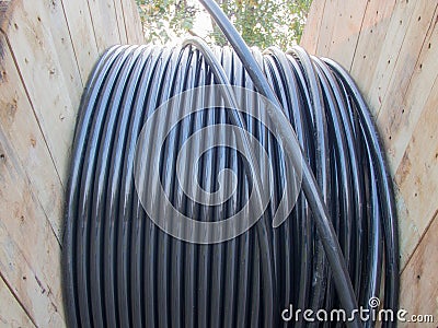 Electric cable in wooden coil Stock Photo