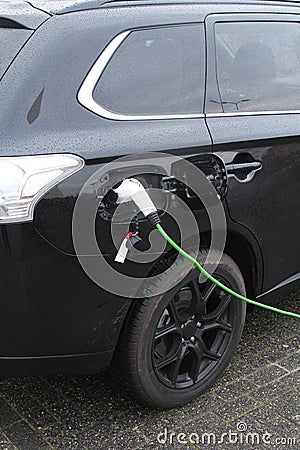 Modern electric plug car charges new electric energy, Netherlands Stock Photo