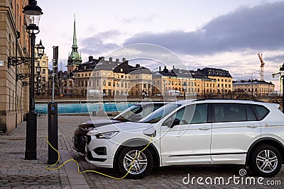 Electric car at the charging point. Sustainability and future of the nature and clean world. Editorial Stock Photo