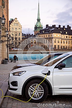 Electric car at the charging point. Sustainability and future of the nature and clean world. Editorial Stock Photo