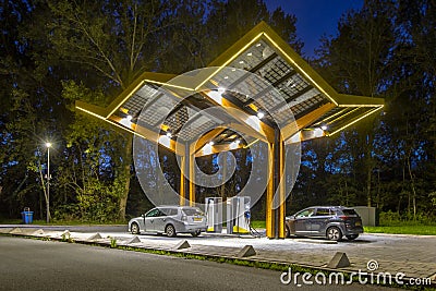 Electric cars charging station at night Stock Photo