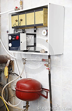 Electric central heating boiler with water heater hot circulation pump and expansion kit in house boiler room. Electric boiler Stock Photo