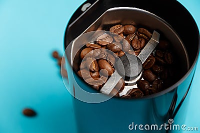 Electric coffee grinder with roasted coffee beans Stock Photo