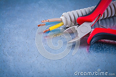 Electric conduct tubing copper cables and sharp wire cutters Stock Photo