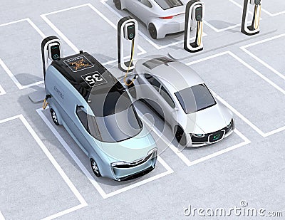 Electric delivery minivan and silver sedan charging at charging station Stock Photo