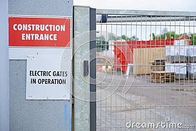 Electric gates in operation at construction site entrance sign Stock Photo