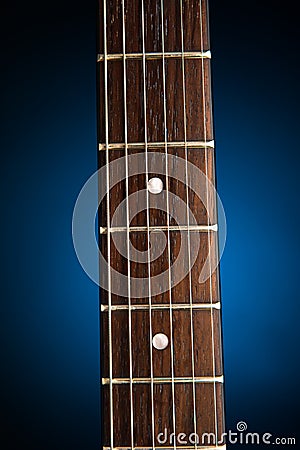 Electric guitar neck, blue background Stock Photo