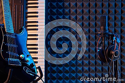 Electric guitar, piano and microphone with professional headphones Editorial Stock Photo