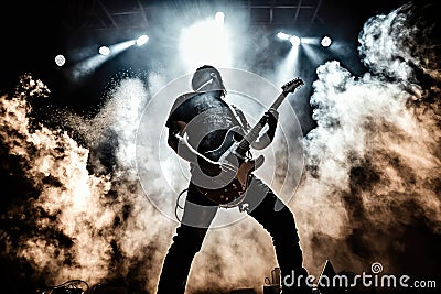 electric guitar player, performing solo concert with dramatic lighting and smoke effects Stock Photo