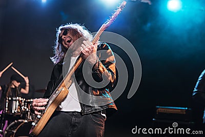 Electric guitar player with rock and roll band performing hard rock music Stock Photo