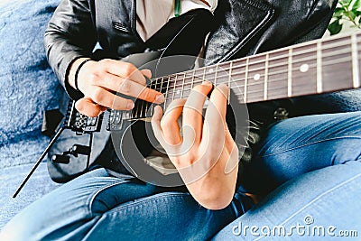 Electric guitar teacher teaching how to place fingers to play a chord Stock Photo