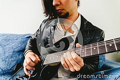 Electric guitar teacher teaching how to place fingers to play a chord Stock Photo