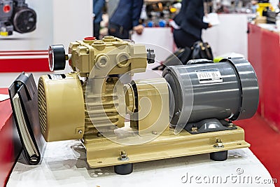 Electric induction motor with compact oil free rotary vane dry vacuum pump for industrial on table Stock Photo