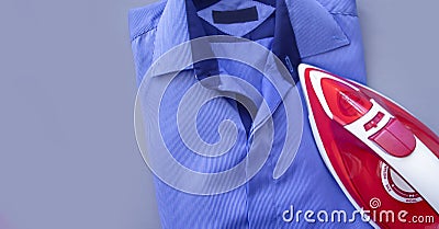 Electric iron blue housewife shirt device garment backgroundn domestic domestic housework Stock Photo