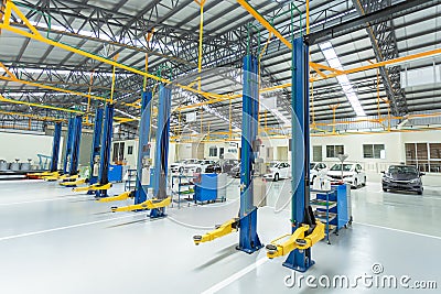 The electric lift for cars, interior car-care center. cars in the service put on the epoxy floor, Car service center Stock Photo