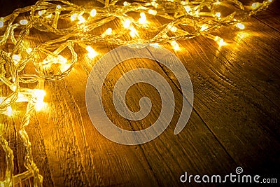 Electric lighted on wooden background Christmas rustic background - vintage planked wood with lights and free text space. Stock Photo