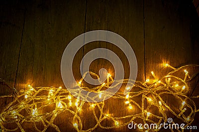Electric lighted on wooden background Christmas rustic background - vintage planked wood with lights and free text space. Stock Photo