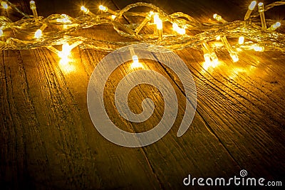 Electric lighted on wooden background Christmas rustic background - vintage planked wood with lights and free text space. Stock Photo