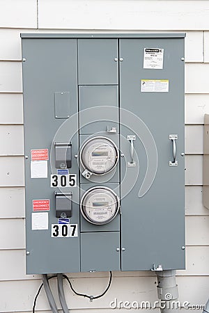 Electric Meters For Apartments are located on the wall outside the building. Close-up Editorial Stock Photo