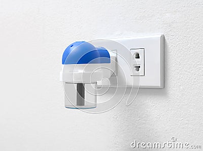 Electric mosquito fumigator plugging on the wall Stock Photo