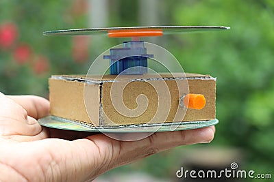 Electric motorized photography turntable held in the hand. Rotatable display table for photography Stock Photo