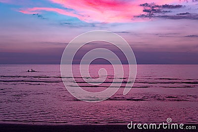 Electric Pink Tropical Sunset over the sea Stock Photo