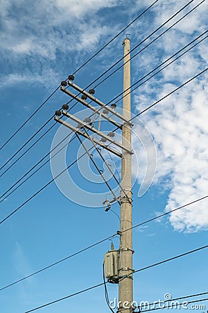 Electric pole and electric transformer with a clear blue sky background in portrait format Stock Photo