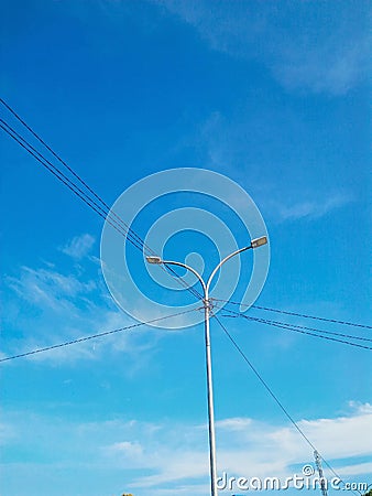 Electric pole full of wires at the crossroads Stock Photo