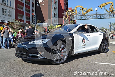 Electric police car Tesla during the 117th Golden Dragon Parade Editorial Stock Photo