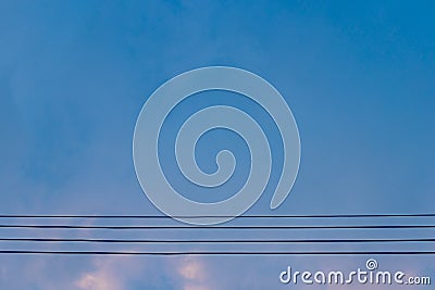 Electric wires on blue sky at evening Stock Photo