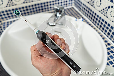 Electric Rechargeable Toothbrush with a Black Handle and Toothbrush Heads Stock Photo