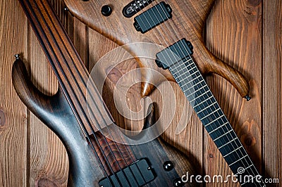 Electric rhythm guitar and five-string bass photographed on a wooden surface Stock Photo