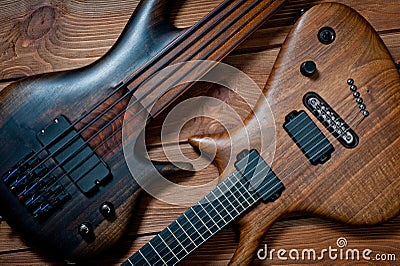 Electric rhythm guitar and five-string bass photographed on a wooden surface Stock Photo