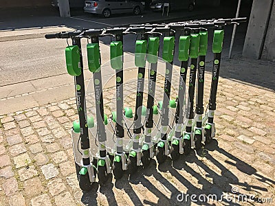 Electric scooters for hire parked in a row E-scooters are a popular means of transport for peopl in cities in cities all over the Editorial Stock Photo