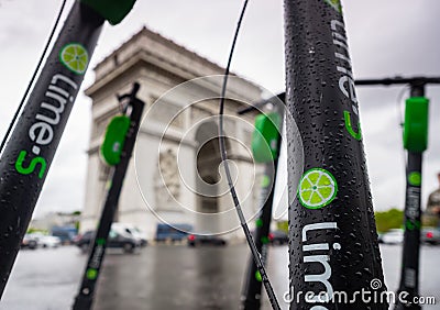 Electric scooters parked and traffic passing in front of Arc de Triomphe in Paris Editorial Stock Photo