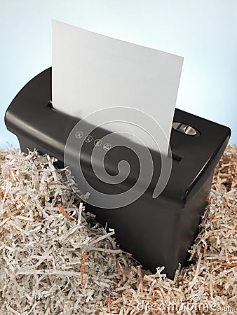 electric shredder surrounded by strips of paper Stock Photo