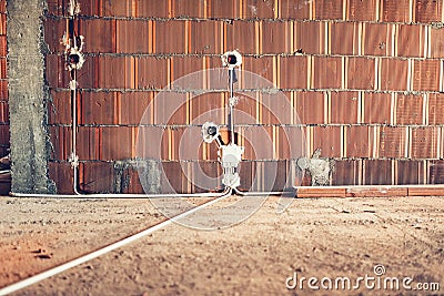 Electric sockets installation in walls at house construction site Stock Photo