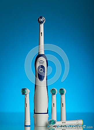 Electric toothbrush and replaceable nozzles of different colors Stock Photo