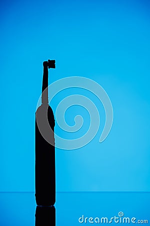 Electric toothbrush silhouette, blue background Stock Photo
