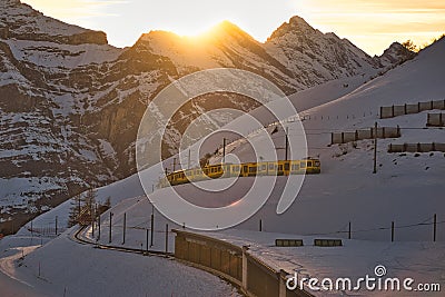 Electric tourist train and Eiger North face, Bernese Oberland, Switzerland. Editorial Stock Photo