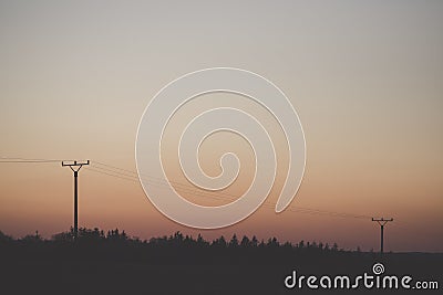 Electric tower cable nature landscape trees energy industry sunset mist Stock Photo