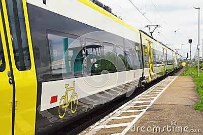 An electric train leaves the train station after passengers have boarded. Editorial Stock Photo