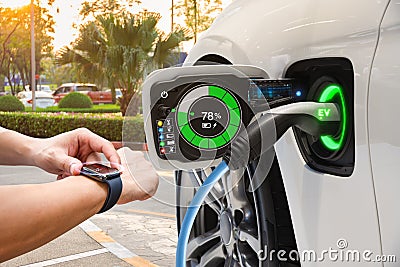 Electric vehicle changing on street parking with graphical user interface synchronize with smart watch, Future EV car concept Stock Photo