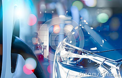 Electric vehicle charging station and EV car in a showroom. Electric vehicle dealership. Clean and sustainable energy. Commercial Stock Photo