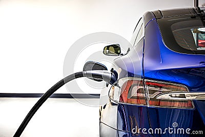 Electric Vehicle charging station system storing power on modern car. EV fuel for advanced hybrid car. automobile industry. Stock Photo