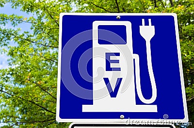 Electric Vehicle Recharging Station Sign with Trees in Background Stock Photo