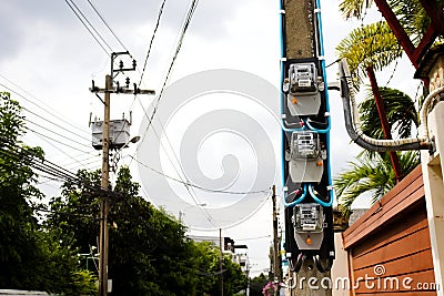 Electric watt meter for house use with transformer pole Editorial Stock Photo