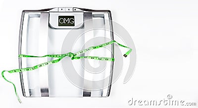 Electrical bathroom scale with measuring tape showing OMG on screen on white background. Health Concept with copy space Stock Photo